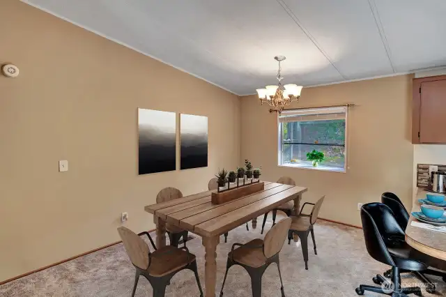Adjoining dining room area with garden window and view of the side yard Garden window great place for herbs and indoor plants.