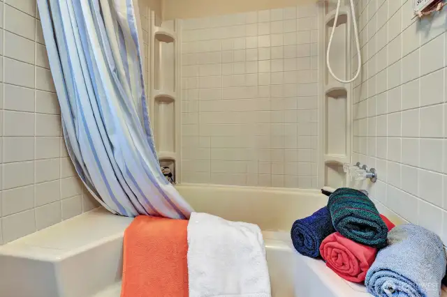 Garden tub in the primary ensuite and commode are in private room. Built in linen cabinet for all your bathing necessities.