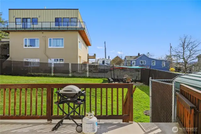 Main deck leading to fully fenced backyard