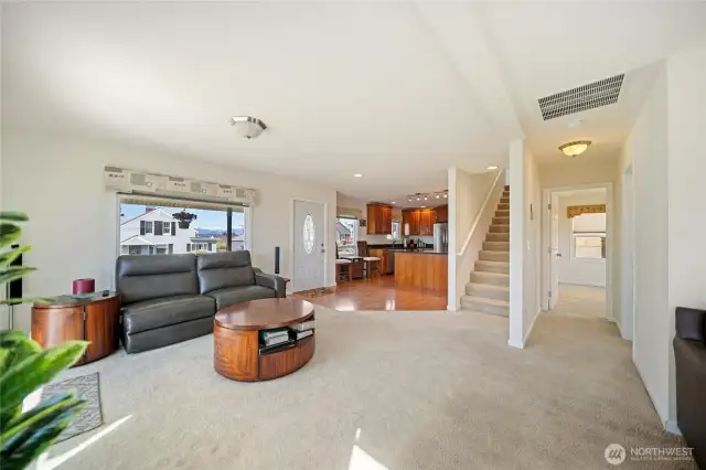 Living room with stairs that leads to the very private primary