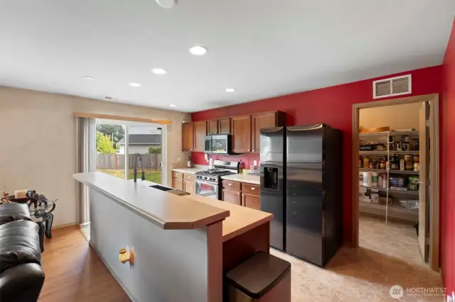 The kitchen offers seamless indoor-outdoor access and excellent connectivity to the main living areas—an ideal layout for hosting dinners and gatherings. Stylish new black stainless appliances.