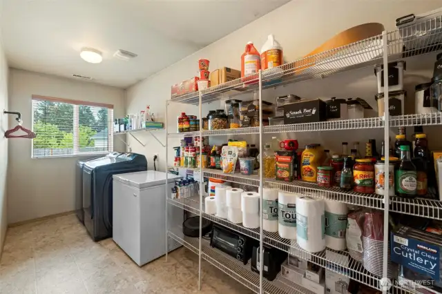 Enjoy the convenience of a spacious walk-in pantry and easy access to the laundry room, all just off the kitchen for added functionality and storage.