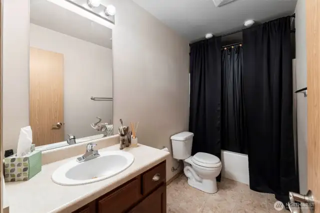 Spacious full guest bathroom located on the upper level, offering privacy and convenience with a central location.