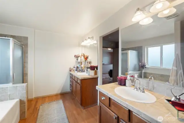 The private ensuite bathroom boasts two separate vanities, offering added convenience and personal space.