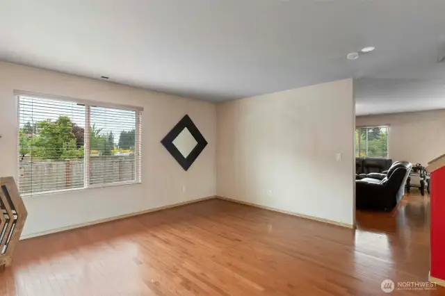 Abundant natural light showcases the gleaming hardwood floors, which extend throughout both the main and upper levels for a cohesive and updated feel.
