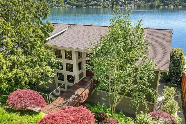 The main residence is surrounded by lush mature landscaping.