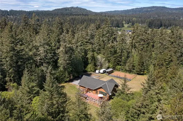 House sits on 1+ cleared acre