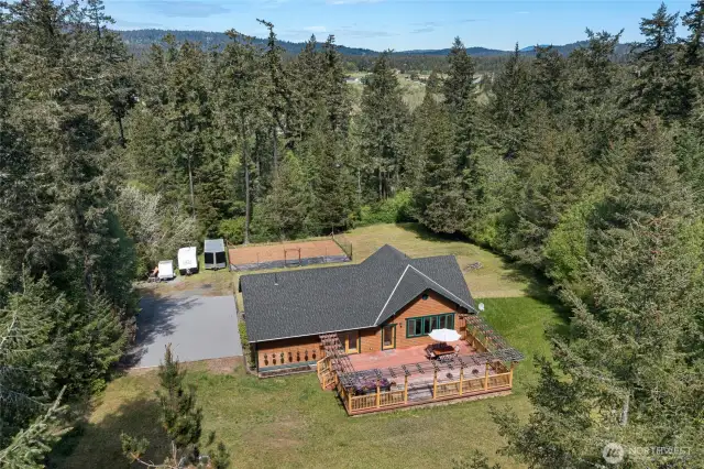 House sits on 1+ cleared acre
