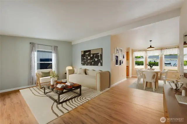 Spacious living area with open flow to dining and patio—perfect for hosting or quiet evenings at home. (Virtually staged)