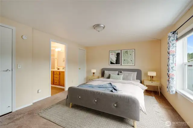 Primary suite offers a roomy layout and easy access to the private bath. (Virtually staged)