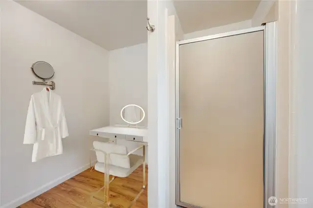 Primary bath with step-in shower and a dedicated space for a make-up vanity or dressing area—designed for comfort and ease. (Virtually staged)