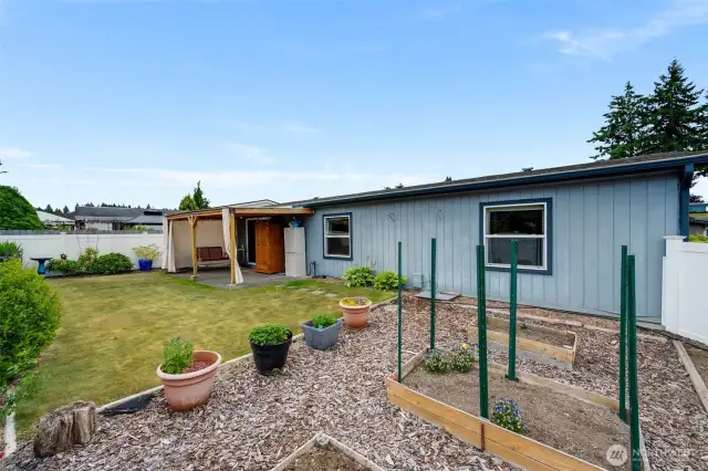 Low-maintenance yard with space for gardening, plus easy access to the covered patio.