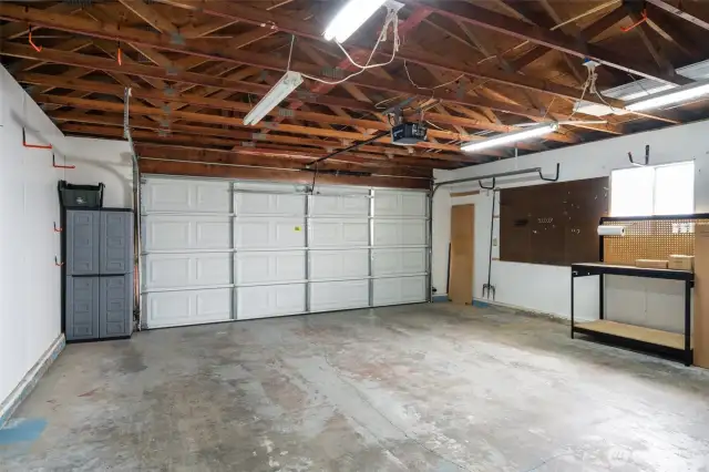 Oversized 2-car garage with workbench area and plenty of room for storage or projects.