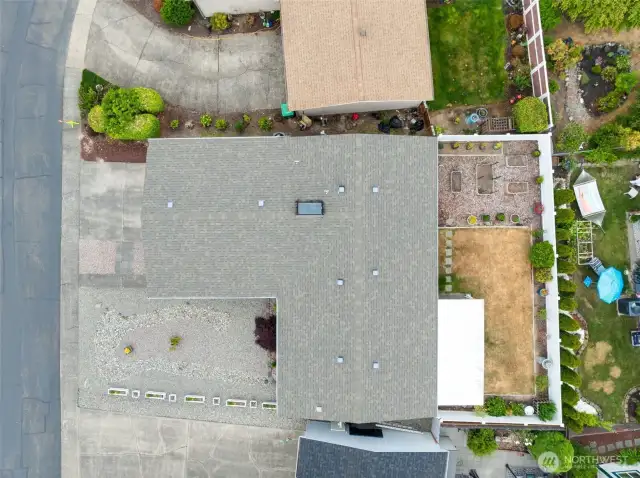 Aerial view showcasing the home’s composition roof that's only 8 years old, low-maintenance front yard and private fenced backyard.