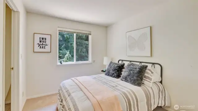Featuring a walk-in closet and attic access, this roomy guest bedroom offers plenty of storage and comfort for your visitors