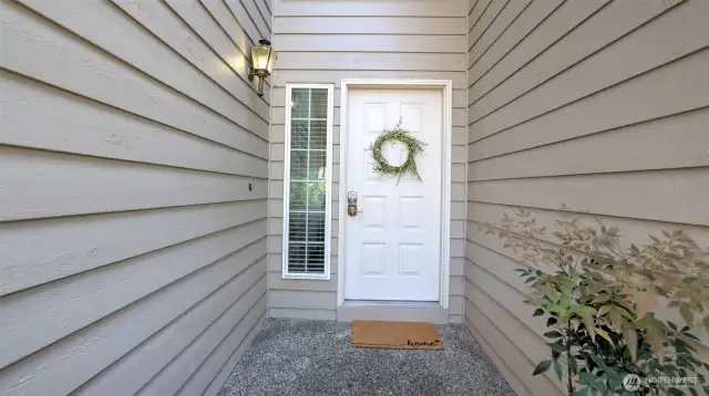 This welcoming private entrance includes a side window beside the front door, creating a bright and airy first impression!