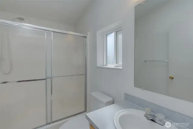Primary bathroom with large walk-in shower.