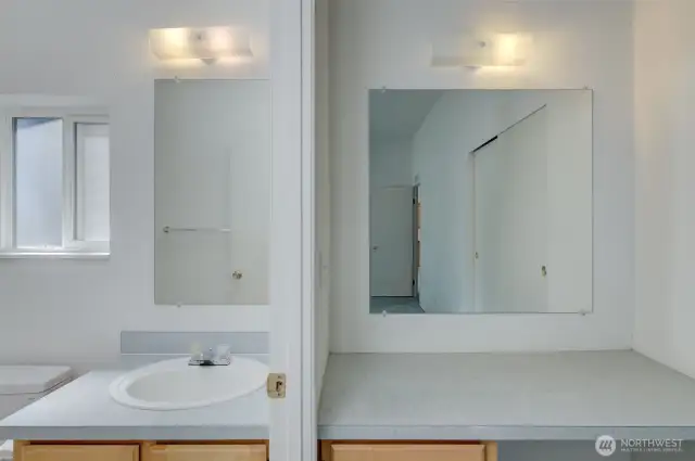 Primary bathroom with small make-up counter to the right.