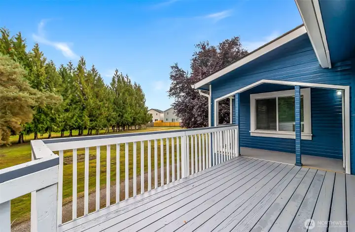 Large deck overlooks the pasture and garden space.