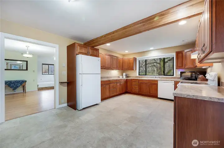 Remodeled kitchen opens to the dining room that boasts original hardwood floors,