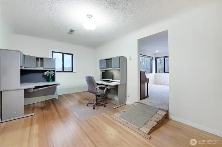 Currently being used as an office, it was the original living room. Coved ceilings and hardwood floors remain