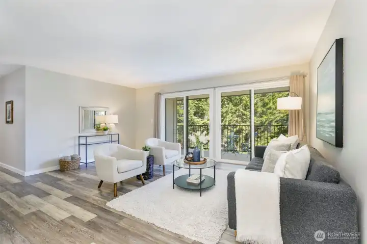 Large and bright living room with full width balcony.