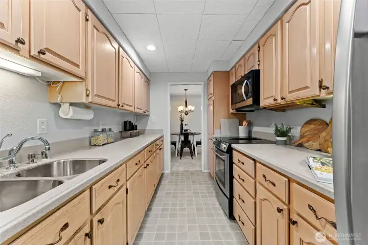 Pullout shelving and smart storage enhance everyday convenience, with an easy flow into the dining area—perfect for both casual meals and entertaining.