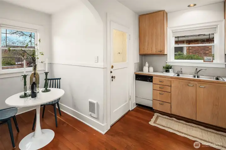 A cased archway leads to a quaint eating nook—perfect for coffee, casual dining, or an evening drink.