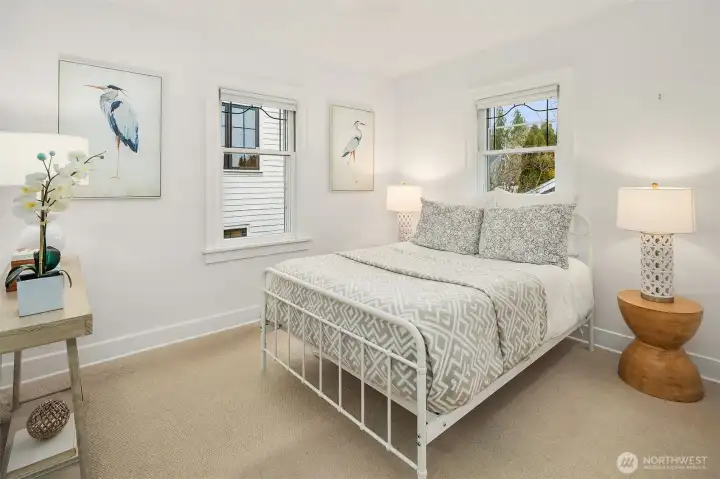The primary bedroom is spacious, offering backyard views that provide both privacy and natural light.