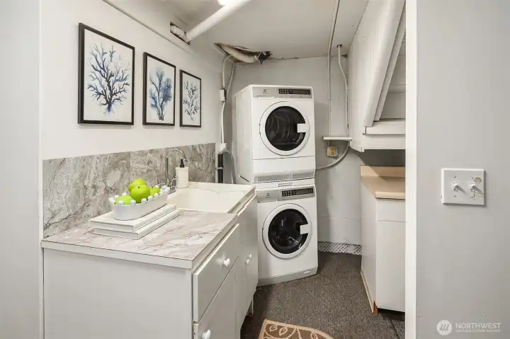 The lower-level kitchenette is well equipped with a washer and dryer, sink, mini fridge and microwave.