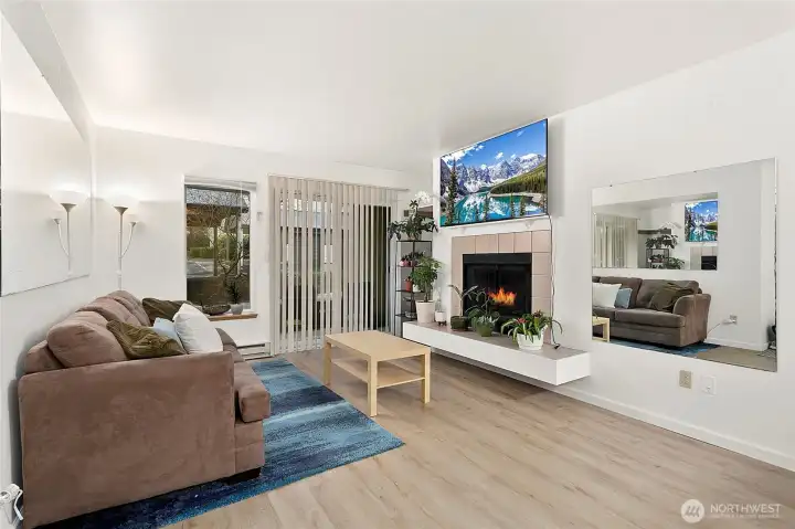 Spacious living room with nice updated flooring and a perch for your art, your plants, or your cat to enjoy.