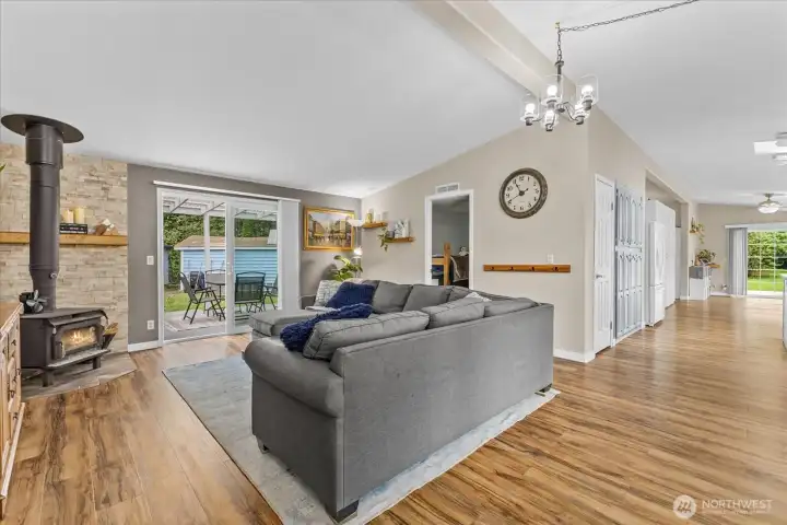 Enter to an open living room with wood burning fireplace