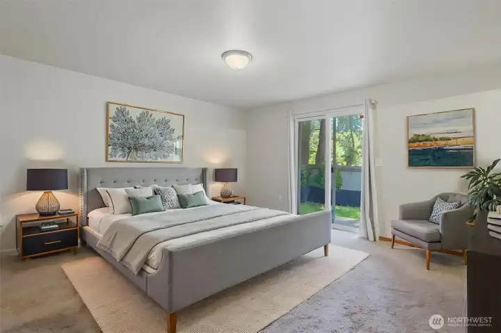 Virtually staged. Spacious primary suite with plush carpet, slider to the backyard, a generous walk-in closet, and room for a king-size bedroom set.