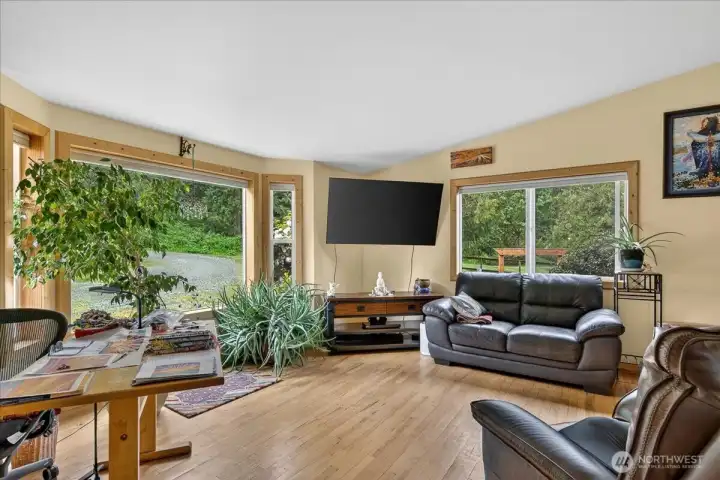 Fall in love with this living room, offering large picture window, open to the dining room & kitchen space. Enjoy the warmth from the wood stove.