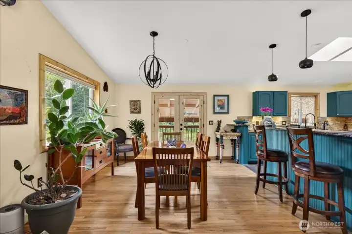 Light filled dining space that is also open to the kitchen and access to the backyard.