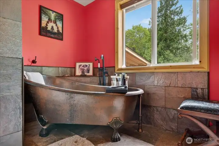 Stunning copper soaking tub located in the primary bathroom suite.