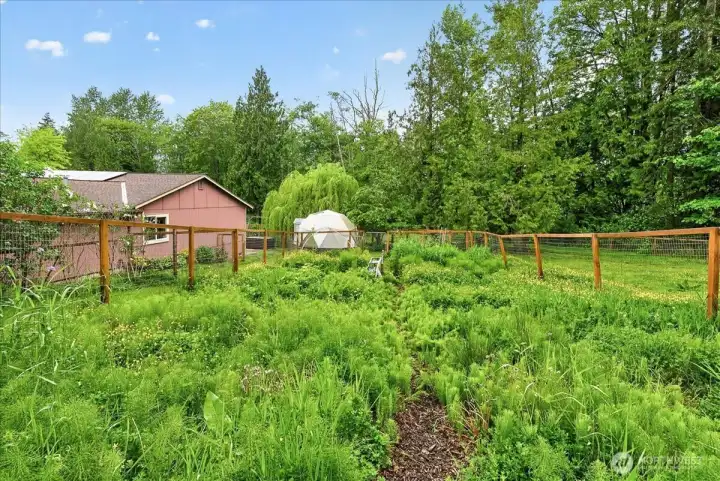 Dedicated garden space that is fully fenced and has a frost free faucet.
