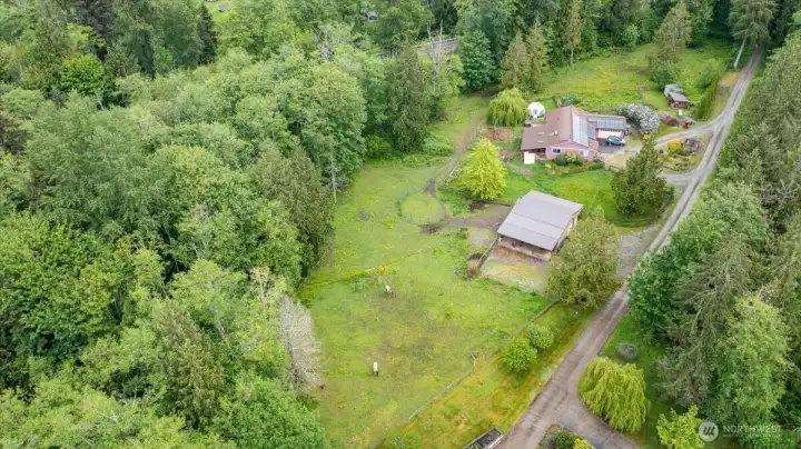 Aerial view facing east - great way to see placement of home, barn/shop, outbuildings & pasture(s).