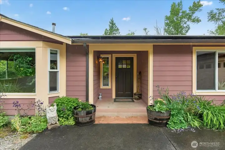 Front entrance to this beautiful Conway home. 3+ bedrooms, 2 bathroom, 2 car oversized garage, shop/barn, greenhouse & additional usable outbuildings.
