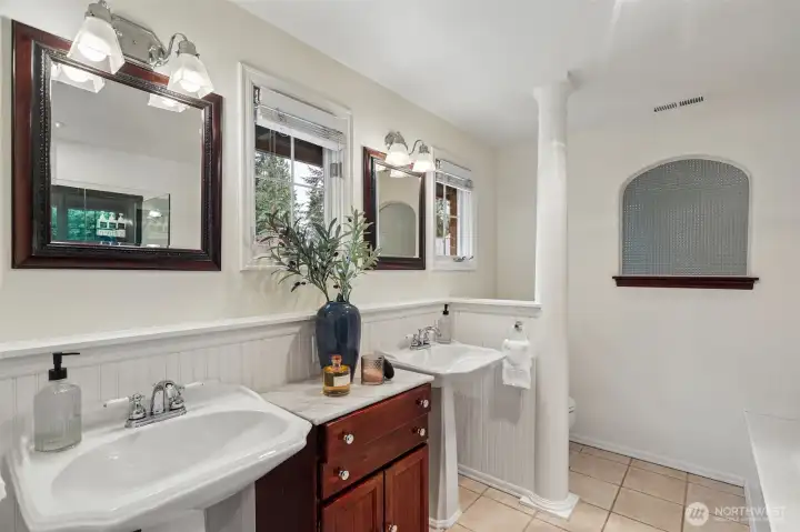 Primary bath with double sinks and stained glass window