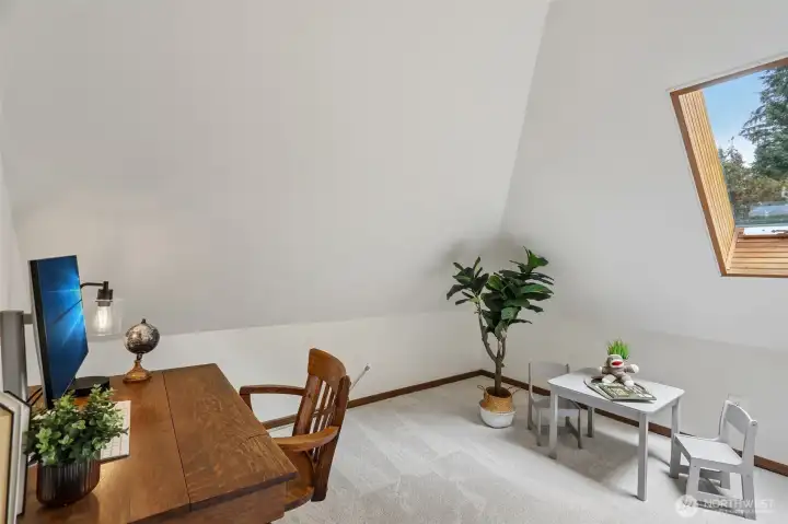Upstairs office with bright wood wrapped skylight