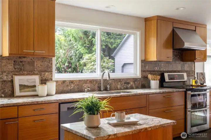 Updated kitchen with granite countertops and morning sun