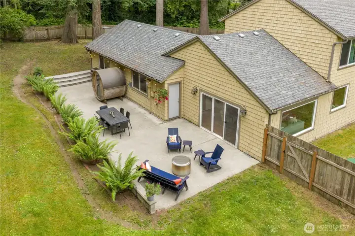 Large fenced-in back yard with grass and space for gardens or RV parking