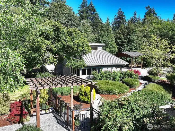 6.5 acres features mature garden, shop with above shop bonus room and 5 stall carport.