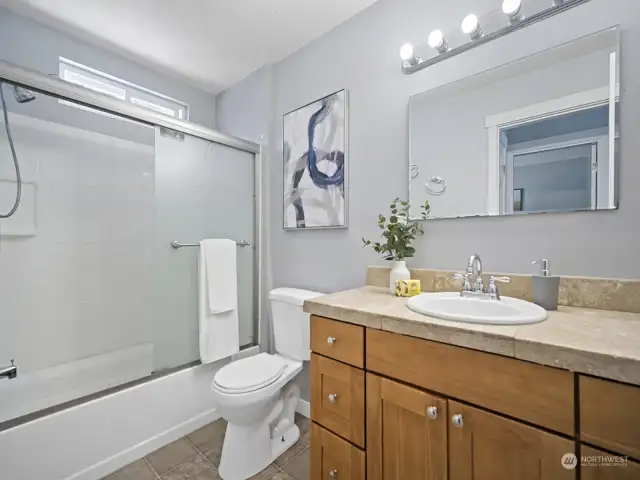Full bathroom with shower / tub combo.