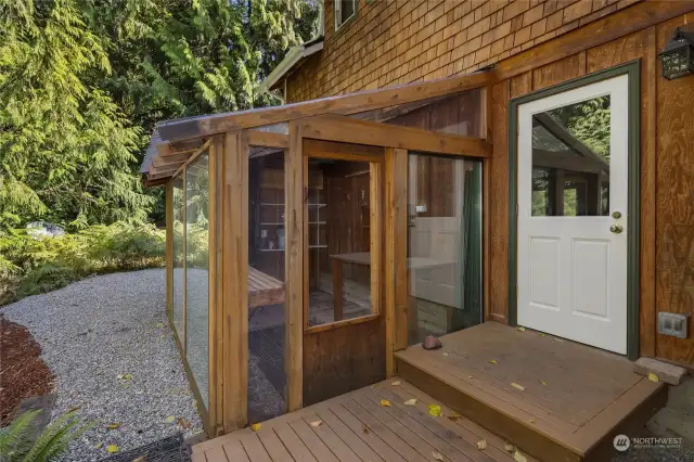 The greenhouse is located at the back of the home off the deck. Not shown is additional parking space at the side of the home for an RV or camper, plus additional gravel parking at the edge of the property.