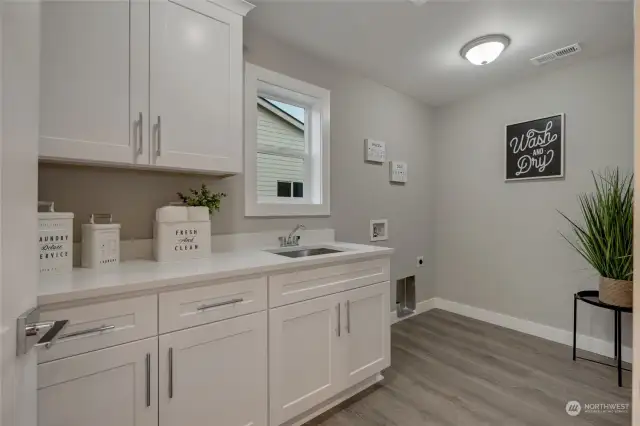 Convenient upstairs laundry with storage  cabinets & sink