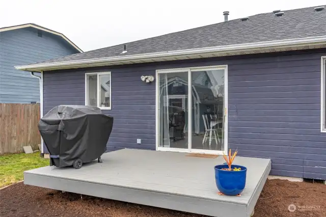 Back deck with sliding glass door into dining room.