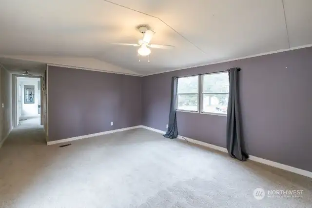 Brand new carpeting in the large living room with windows, side door access, and lots of space. Freshly painted.