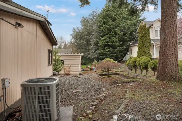 This home features a heat pump to keep you warm in the winter and cool in the summer! The low-maintenance yard also has some raised-garden spaces.